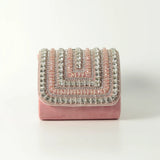 Pink Nysa Mini Bag with embroidered handle by The Tan Clan, showcasing a compact design and detailed handle embroidery.