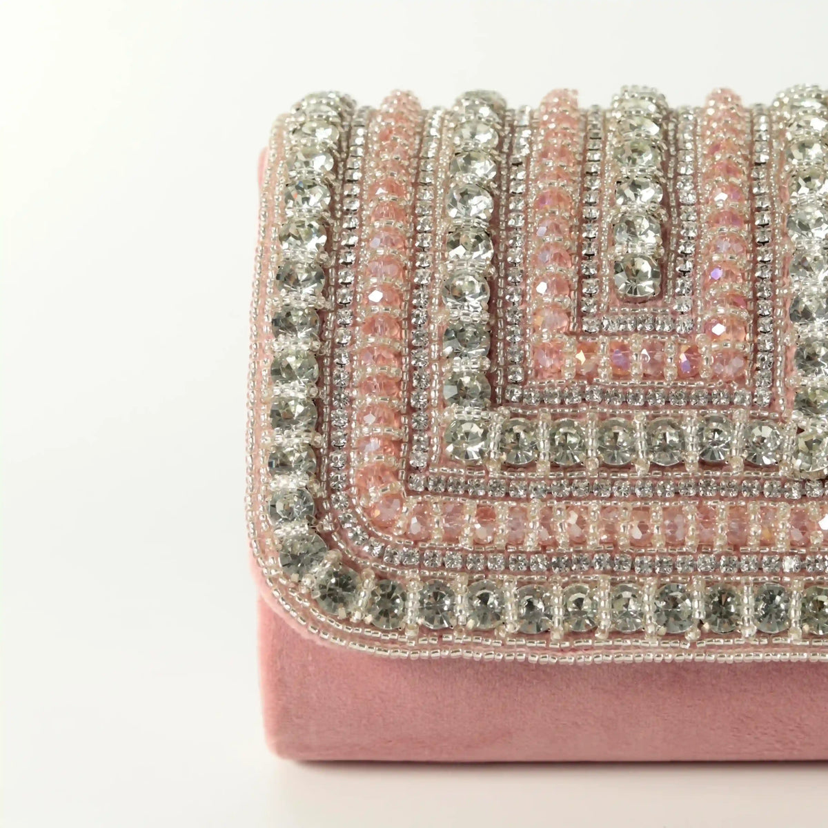 Pink Nysa mini bag by The Tan Clan with embroidered handle, featuring a compact design and stylish craftsmanship.
