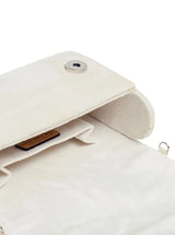 White embellished flap-over clutch bag by The Tan Clan featuring elegant detailing and a sleek design.