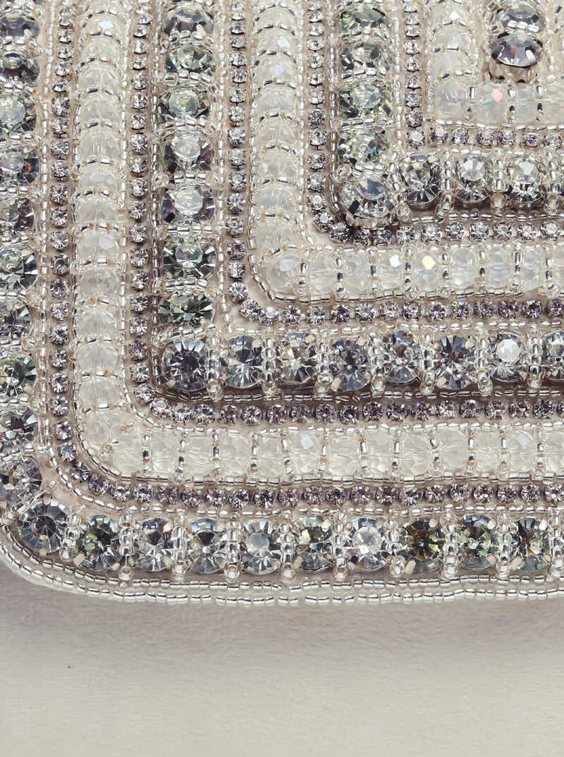 White Nysa clutch bag with embellished flap from The Tan Clan, featuring a stylish and elegant design perfect for evening accessories.