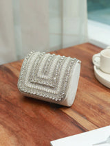 Nysa white mini bag with embroidered handle by The Tan Clan, featuring a compact design and detailed embroidery.