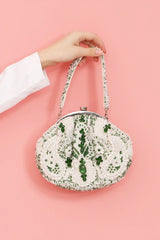 Tan Clan Paak Batua bag with detachable strap, featuring a woven design and compact shape, ideal for versatile everyday use.
