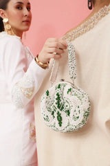 Tan Clan Paak Batua bag with detachable strap, showcasing traditional design and versatile carry options.
