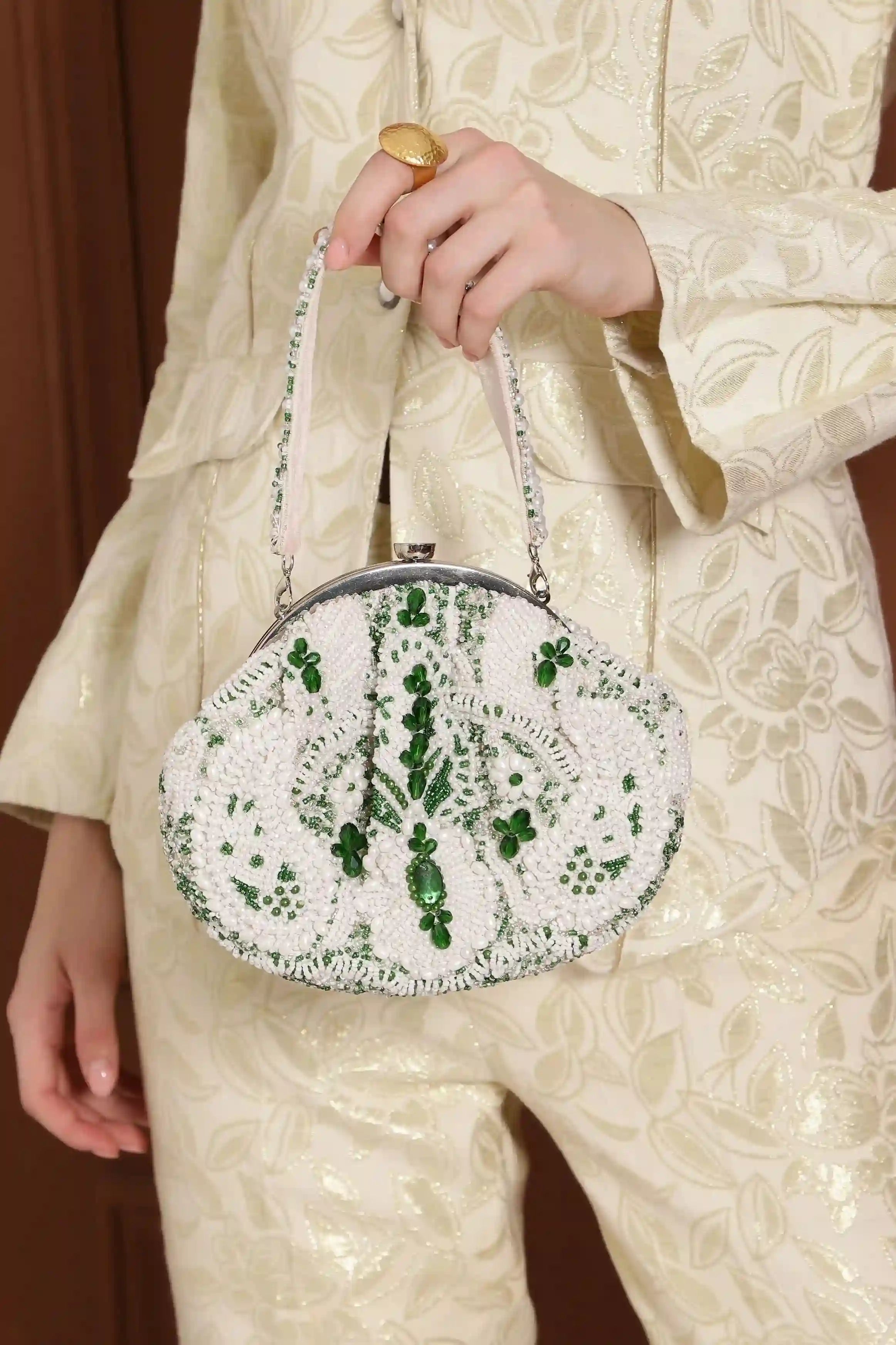 Tan Clan Paak Batua bag with detachable strap, featuring traditional design and fabric details, shown with the strap attached.