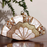 Pankh Golden Brass Mother of Pearl Clutch by The Tan Clan with intricate brass and mother of pearl design, paired with a Batua bag.