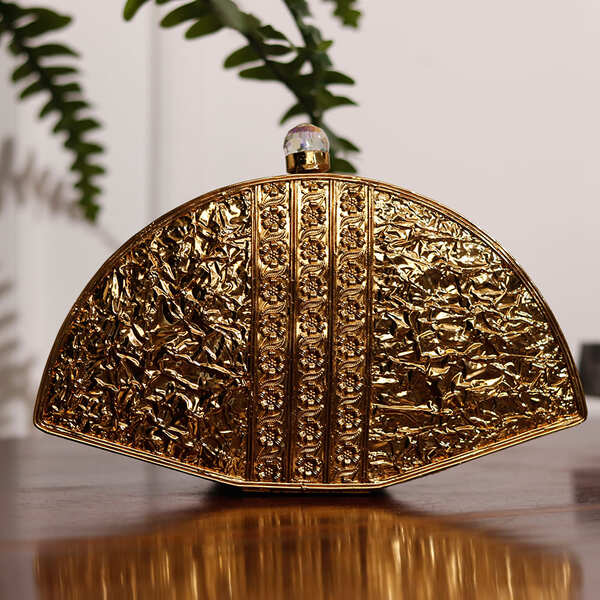 Golden brass Pankh Mother of Pearl clutch bag by The Tan Clan with intricate detailing and elegant design.
