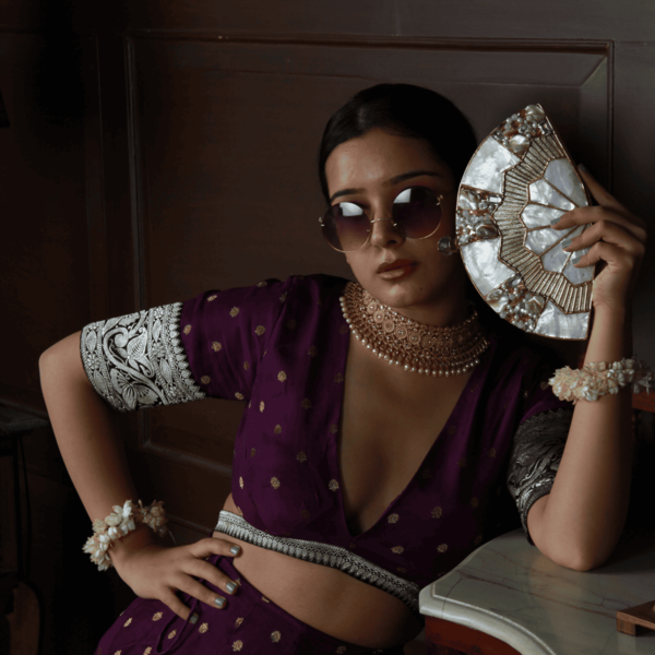 Golden brass clutch with mother of pearl details by The Tan Clan, featuring a sleek, elegant design and intricate craftsmanship.