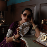 Golden brass Pankh clutch with mother of pearl accents by The Tan Clan, featuring intricate design and elegant craftsmanship.