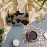 Hand-embroidered Patcher clutch bag by The Tan Clan featuring intricate patchwork and vibrant embroidery, stylish accessory for any occasion.