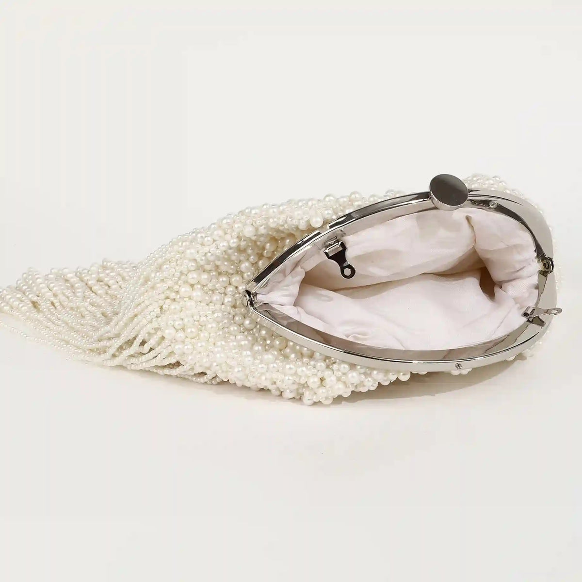 Pearl Batua bag with tassels from The Tan Clan, featuring a traditional design and intricate pearl detailing.