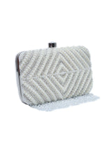 Pearly silver hand-embroidered clutch bag with intricate detailing, stylish accessory by The Tan Clan.