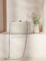 Pearly silver handcrafted clutch with intricate hand embroidery from The Tan Clan, featuring a sleek design and elegant detailing.