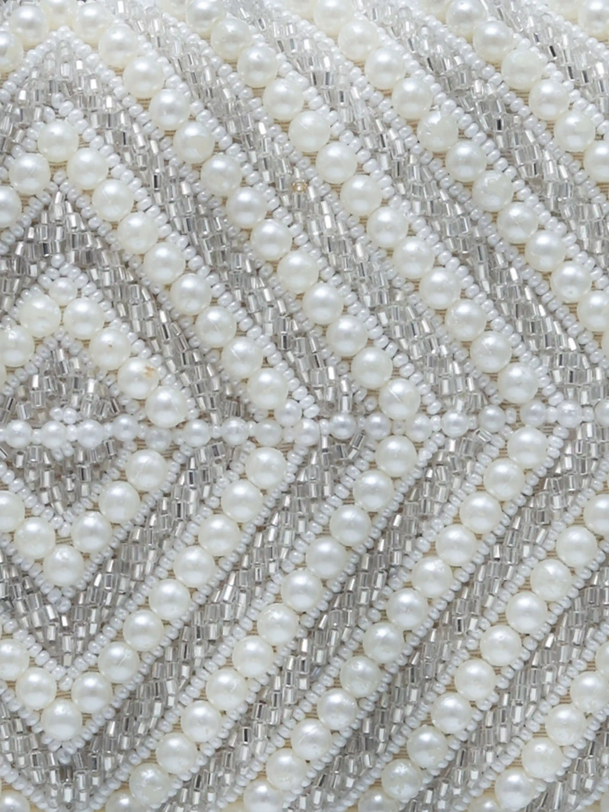 Pearly silver hand-embroidered clutch bag with intricate embroidery and elegant design from The Tan Clan.