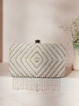 Pearly silver hand-embroidered clutch bag with intricate floral designs from The Tan Clan, showcasing elegant craftsmanship and style.