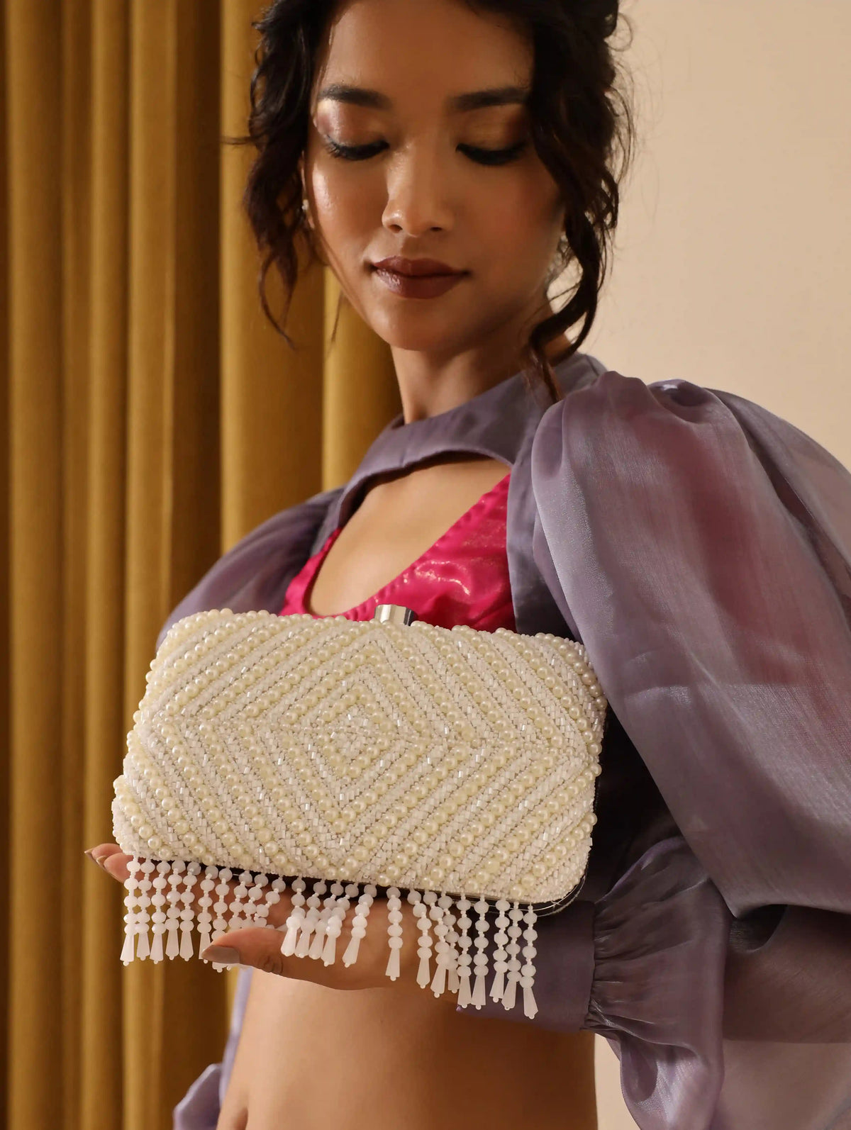 Pearly white hand-embroidered clutch bag with intricate floral designs from The Tan Clan, featuring a sleek, elegant style.