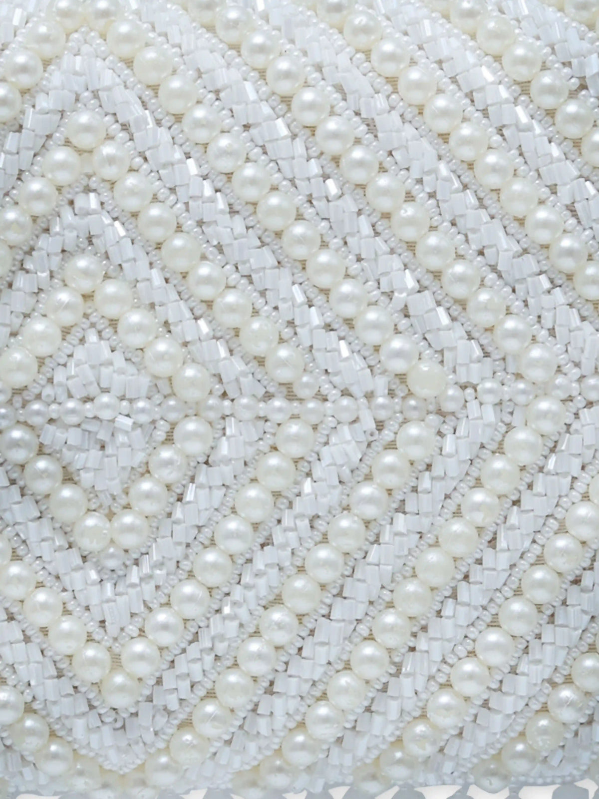 Pearly White hand-embroidered clutch bag by The Tan Clan with intricate floral embroidery and elegant design.