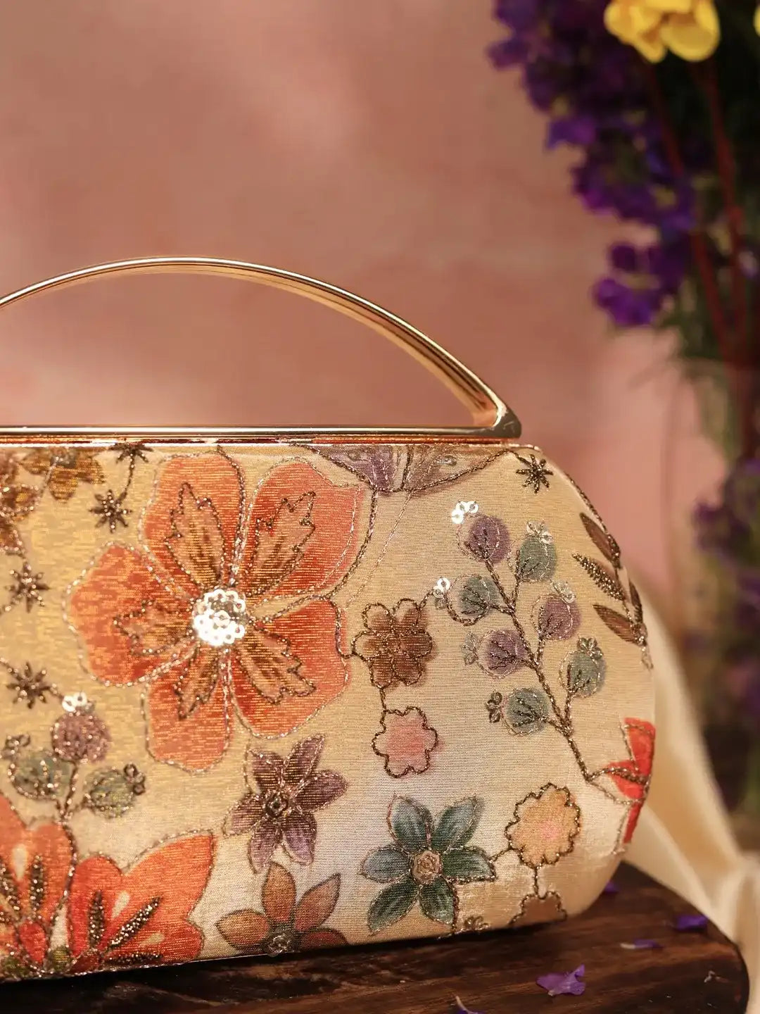 Petal beige capsule clutch bag by The Tan Clan featuring a sleek, rounded design with a textured finish and minimalist style.