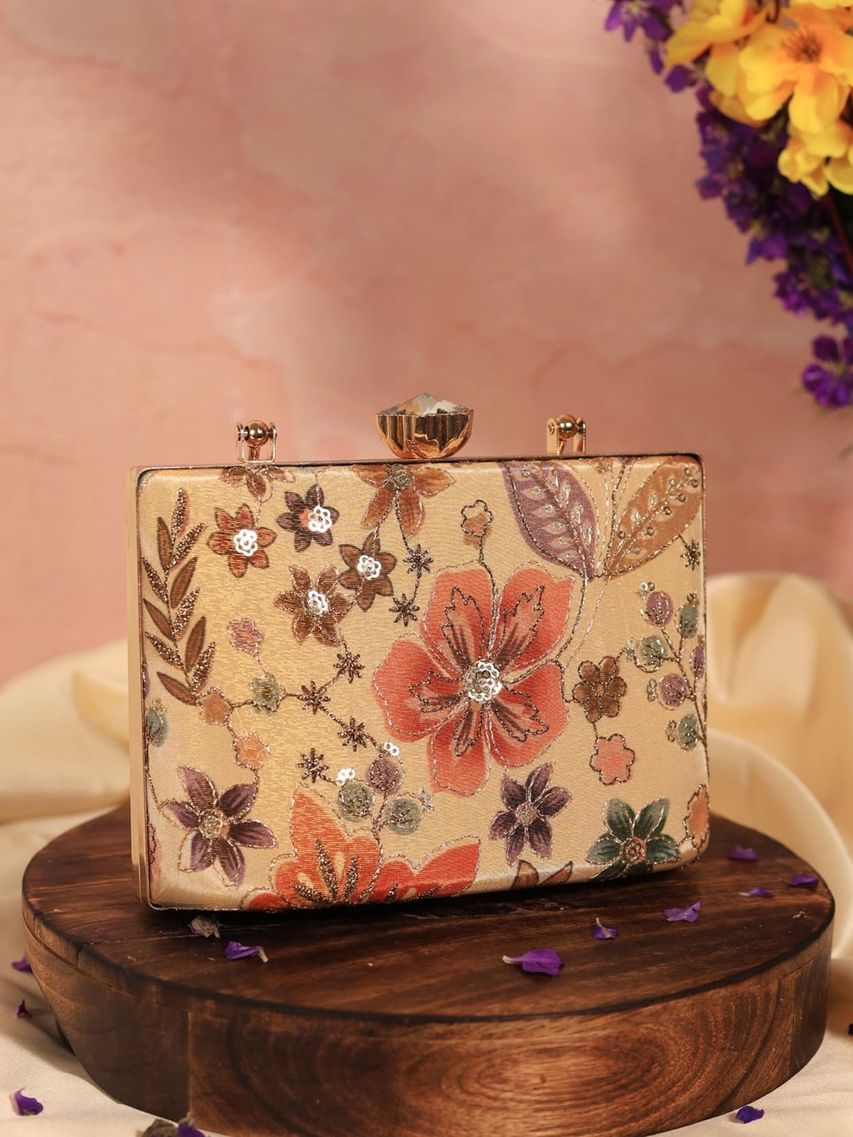Petal beige casket clutch by The Tan Clan featuring a sleek, elegant design with a textured finish and gold-tone clasp.