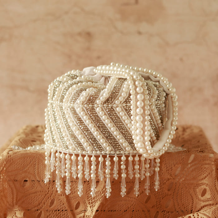 Petite embroidered mini potli bag with glass bead hangings by The Tan Clan, showcasing intricate embroidery and decorative beads.