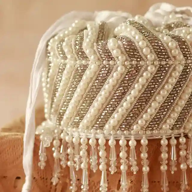 Petite embroidered mini potli bag by The Tan Clan with glass bead hangings and intricate embroidery, perfect for traditional occasions.