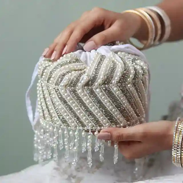 Petite embroidered mini potli bag by The Tan Clan with glass bead hangings and intricate embroidery for traditional occasions.
