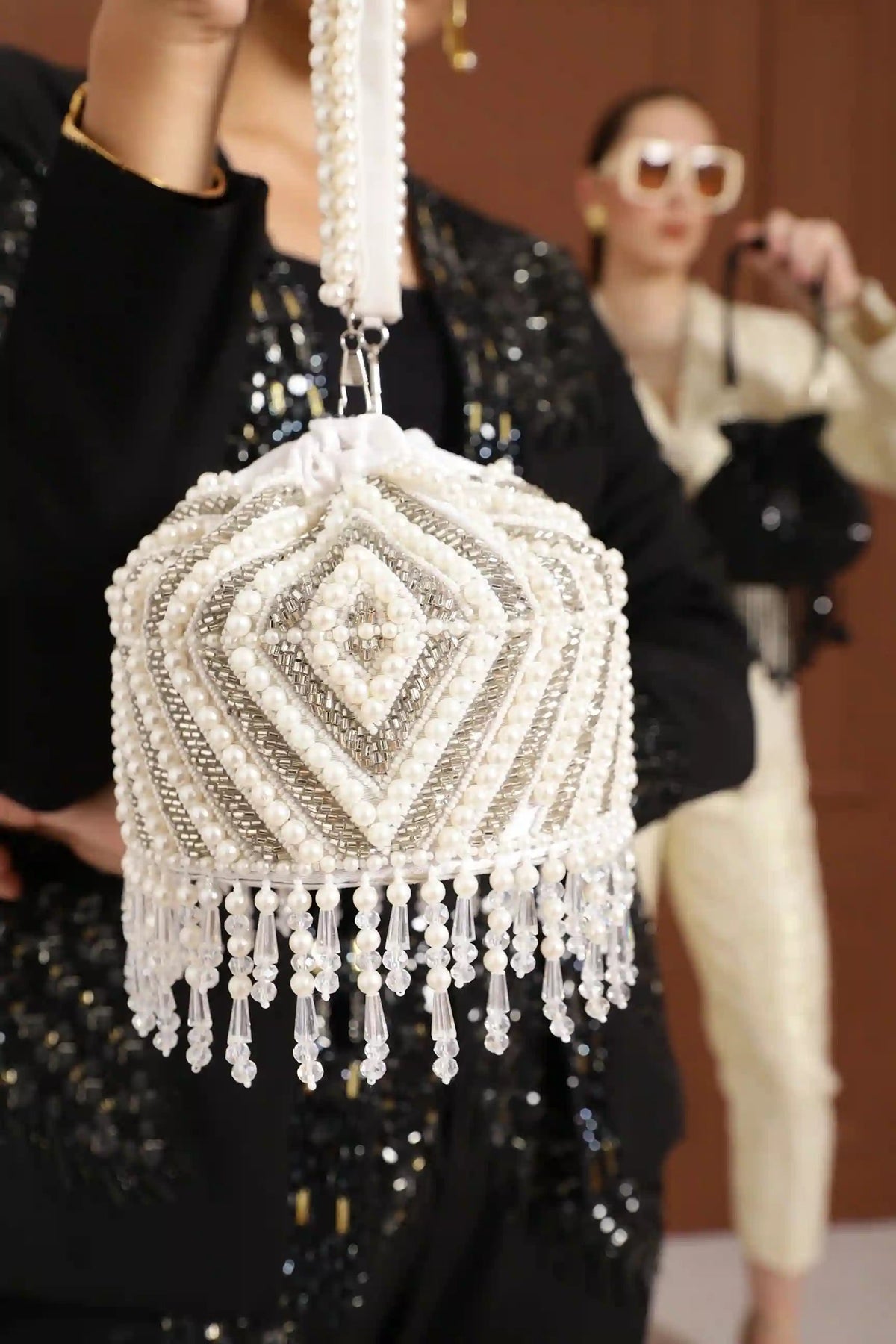 Petite embroidered mini potli bag by The Tan Clan with glass bead hangings, featuring intricate embroidery and a traditional design.