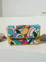 Multicolor Poppy Baguette Bag with handle by The Tan Clan, showcasing vibrant woven design and compact shape.