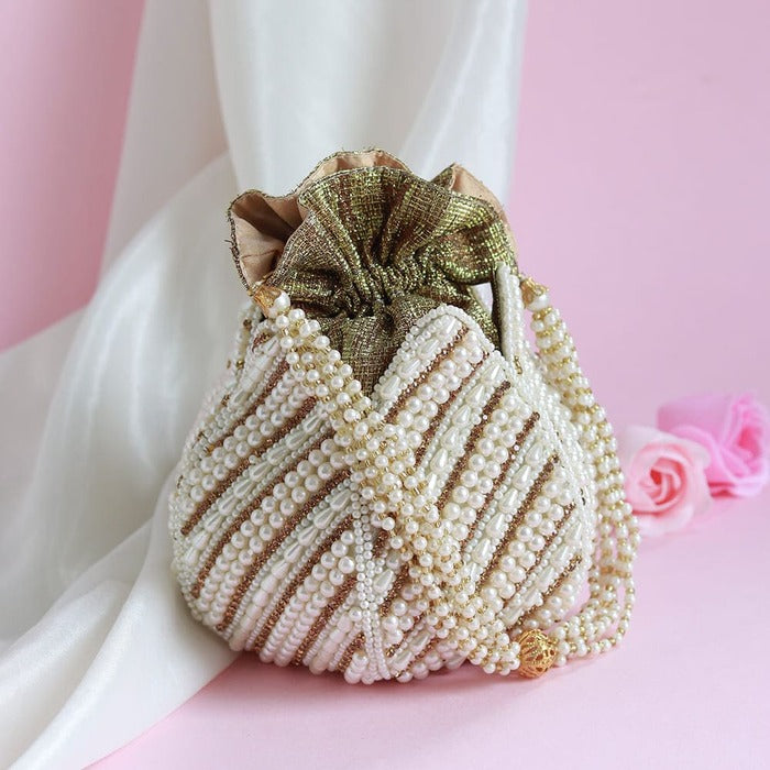 Hand embroidered Purva Mini Lotus Potli bag by The Tan Clan with intricate floral embroidery and traditional design.