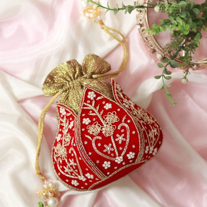 Mini lotus-shaped potli bag with Pushp Zardozi embroidery by The Tan Clan, featuring intricate gold thread work and decorative details.
