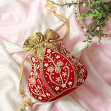 Mini lotus-shaped potli bag with Pushp Zardozi embroidery by The Tan Clan, featuring intricate gold thread work and decorative details.