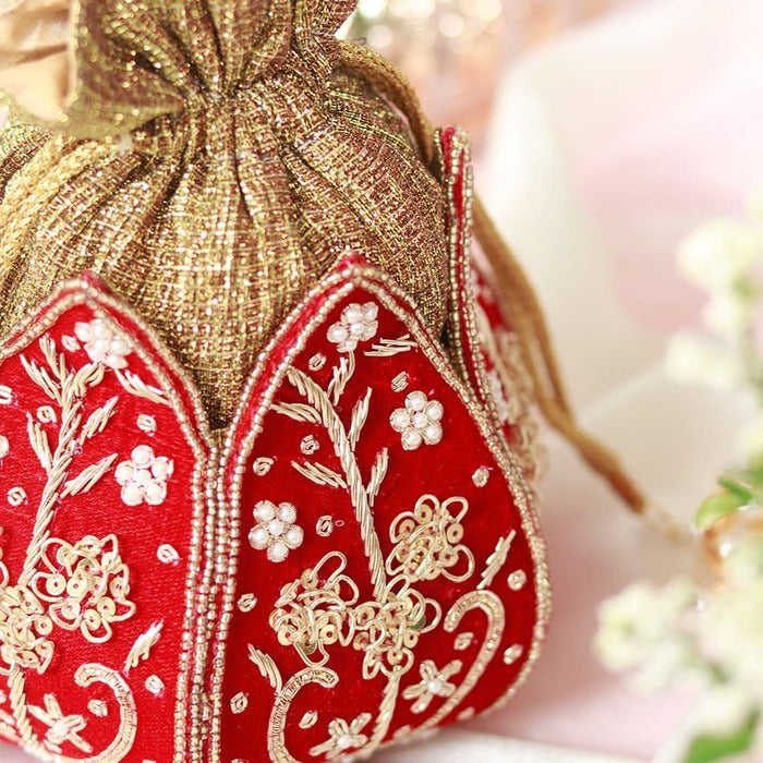 Mini lotus-shaped Potli bag with Pushp Zardozi embroidery by The Tan Clan, featuring intricate gold thread work.