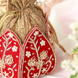 Mini lotus-shaped Potli bag with Pushp Zardozi embroidery by The Tan Clan, featuring intricate gold thread work.
