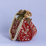 Mini lotus-shaped potli bag with Pushp Zardozi embroidery by The Tan Clan, featuring intricate gold and colorful threadwork.