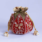 Pushp Zardozi embroidered mini lotus potli bag by The Tan Clan featuring intricate gold embroidery and a drawstring closure.