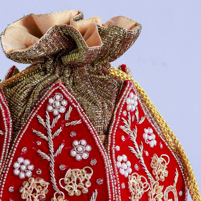 Pushp Zardozi embroidered mini lotus potli bag by The Tan Clan with intricate gold thread embroidery and decorative tassels.