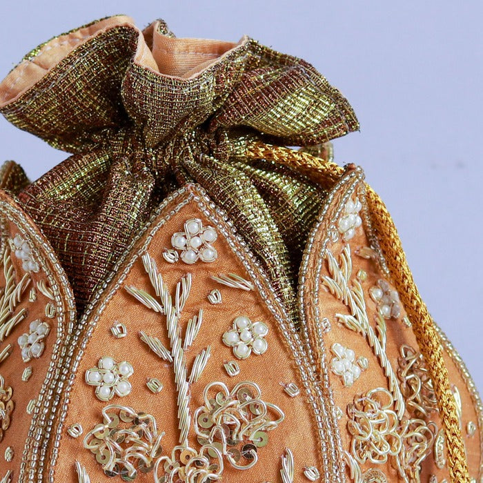 Mini lotus-shaped potli bag with Pushp Zardozi embroidery by The Tan Clan, featuring intricate gold threadwork and traditional design.