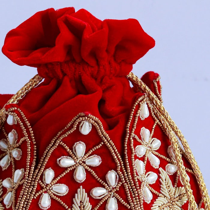 Hand-embroidered Pushya mini lotus potli bag by The Tan Clan with intricate embroidery and a drawstring closure.