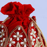 Hand-embroidered Pushya mini lotus potli bag by The Tan Clan with intricate embroidery and a drawstring closure.