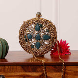 Qurbat embellished brass clutch by The Tan Clan with intricate design and decorative accents, stylish accessory for special occasions.