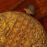 Qurbat embellished brass clutch by The Tan Clan featuring intricate designs and a sleek, elegant finish for stylish occasions.