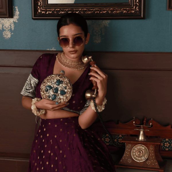 Embellished brass clutch bag with intricate details from The Tan Clan, featuring a sleek design and elegant craftsmanship.