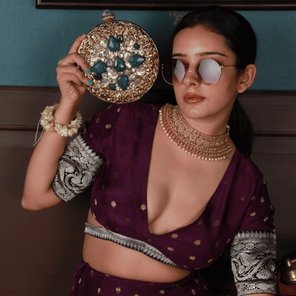 Embellished brass clutch bag with intricate detailing by The Tan Clan, featuring a sleek design and elegant craftsmanship.