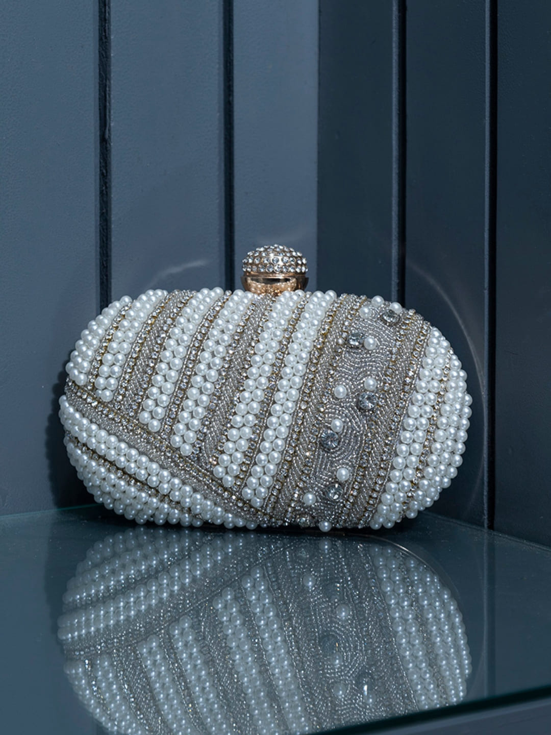 Rabia silver hand-embroidered pearl clutch by The Tan Clan showing intricate embroidery and pearl details on a sleek evening bag.