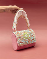 Rainbow embellished flap-over clutch bag by The Tan Clan featuring vibrant rainbow accents and a sleek design.