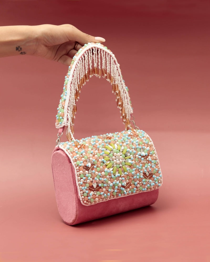 Rainbow embellished flap-over clutch bag by The Tan Clan with colorful decorative details on smooth leather surface.