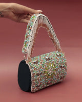 Rainbow embellished flap-over clutch bag by The Tan Clan, featuring vibrant rainbow accents and a sleek, stylish design.