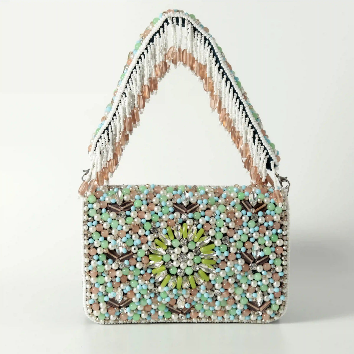 Rainbow-embellished flap-over clutch bag by The Tan Clan with colorful rainbow decorations and sleek design.