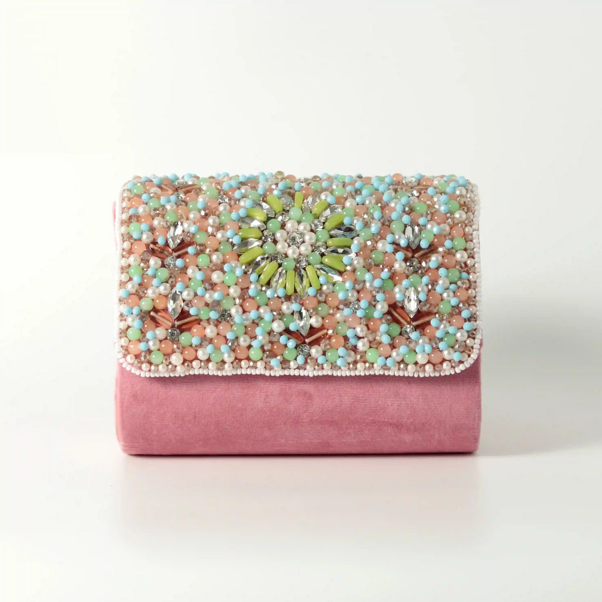 Rainbow embellished flap-over clutch bag by The Tan Clan with colorful decorative accents and a sleek design.