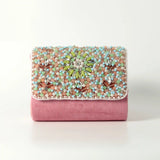 Rainbow embellished flap-over clutch bag by The Tan Clan with colorful decorative accents and a sleek design.