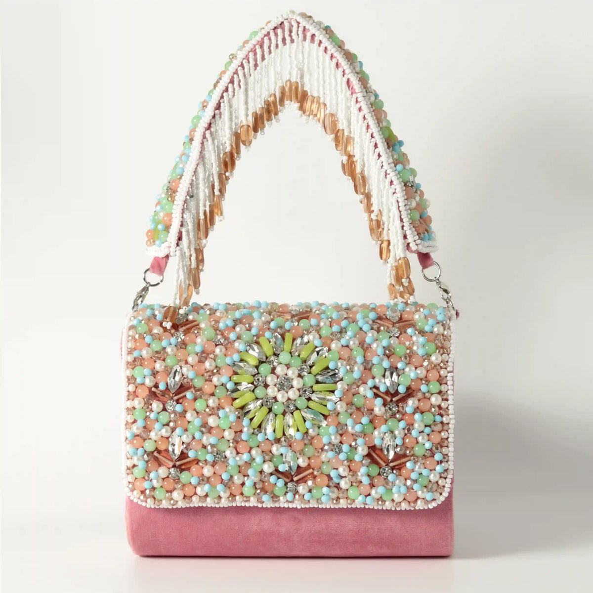 Rainbow embellished flap-over clutch bag by The Tan Clan, featuring colorful rainbow details and a sleek design.